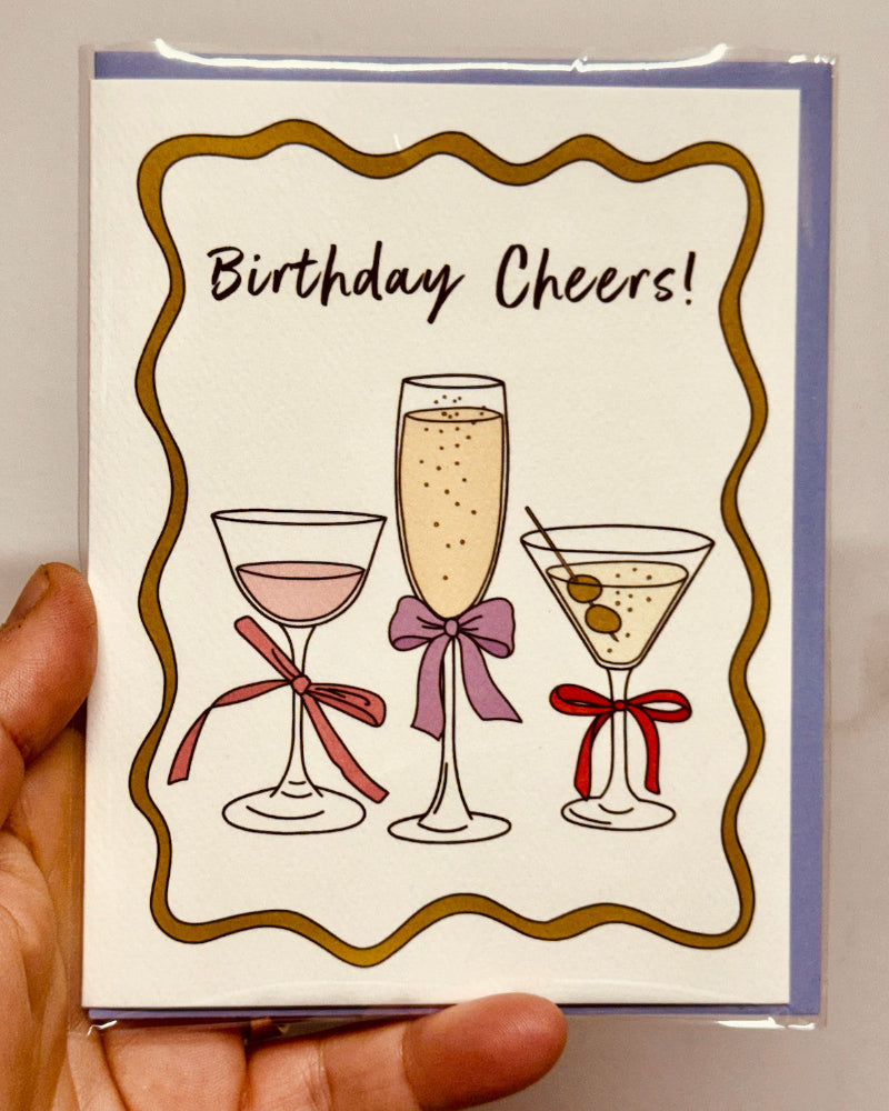 Birthday card with illustrations of cocktails and 'Birthday Cheers!' text