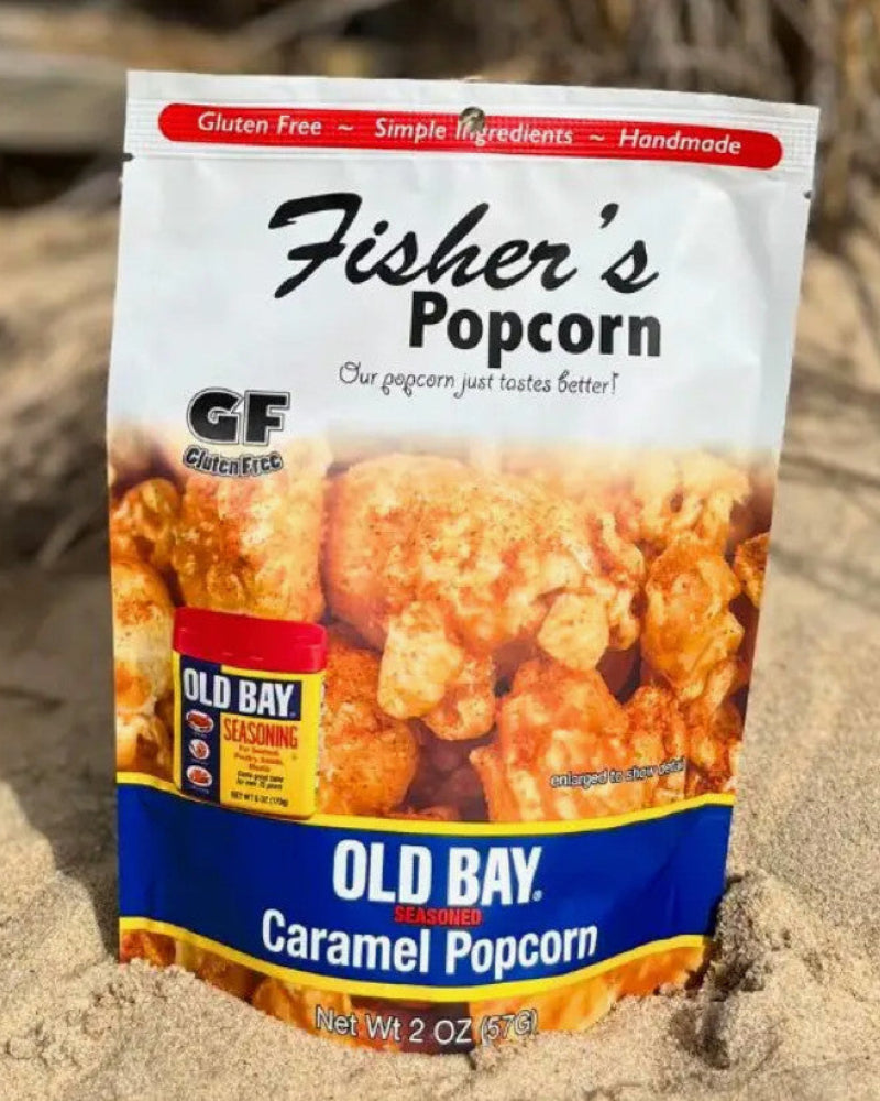 Fisher's Popcorn Old Bay Caramel Popcorn package on sand