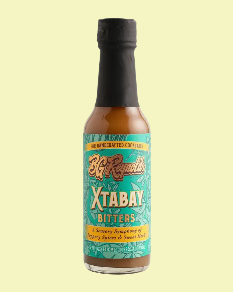A bottle of BG RENOLDS XTABAY BITTERS on a light green background