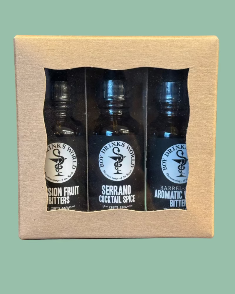 Three bottles of Bitter's World bitters in a cardboard packaging on a green background