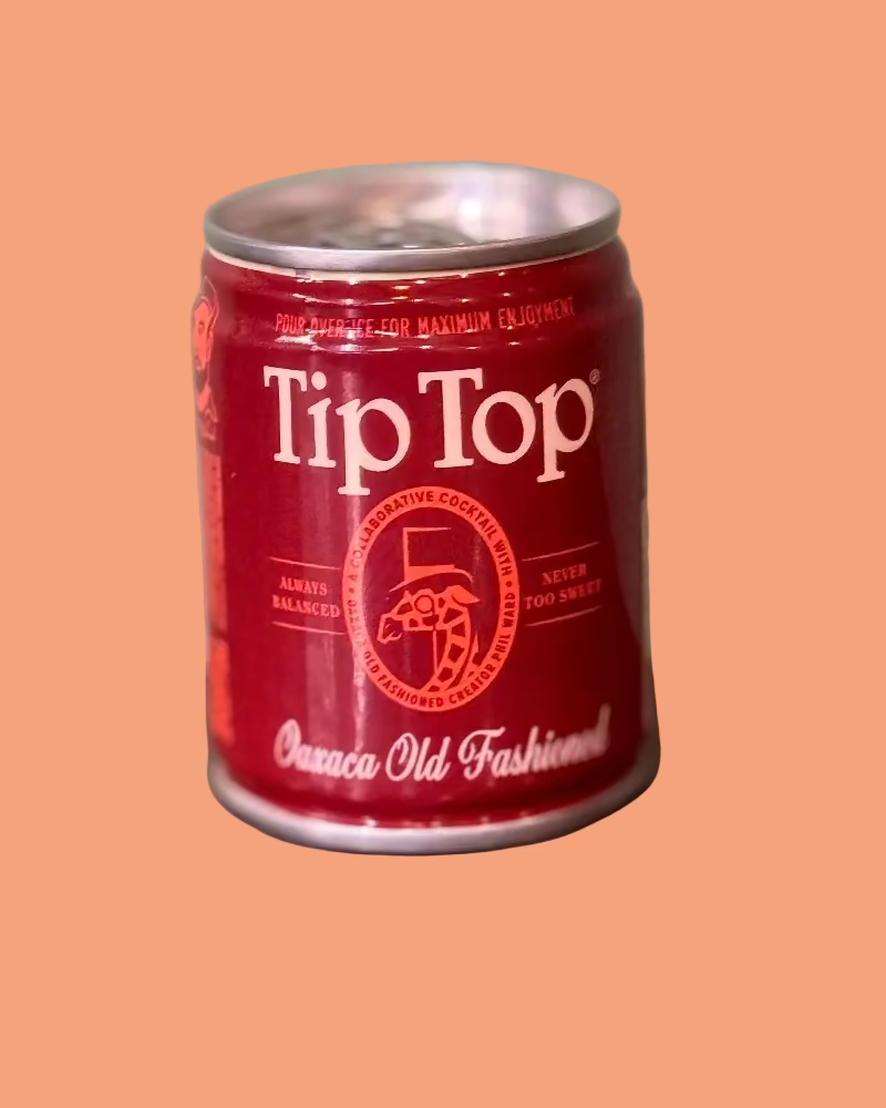 Red can of Tip Top Old Fashioned on a peach background