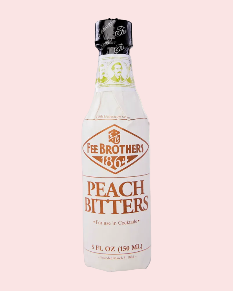 Bottle of Fee Brothers Peach Bitters on a pink background