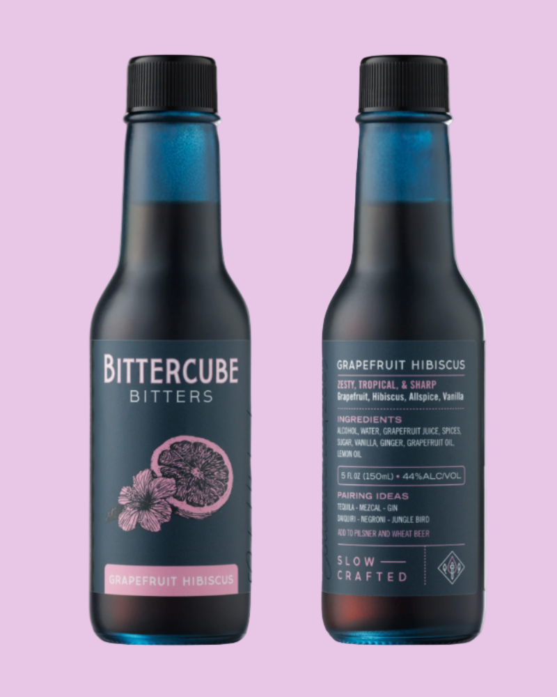 Two bottles of Bittercube Bitters on a pink background