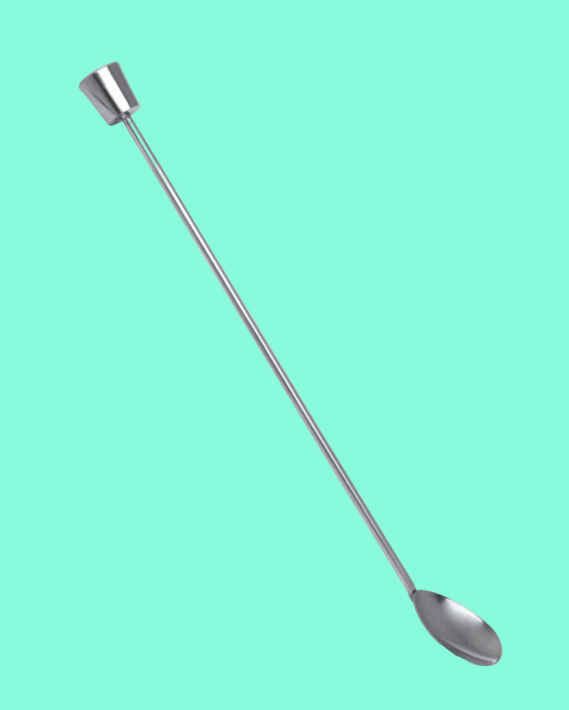 Metallic spoon with a long handle on a teal background