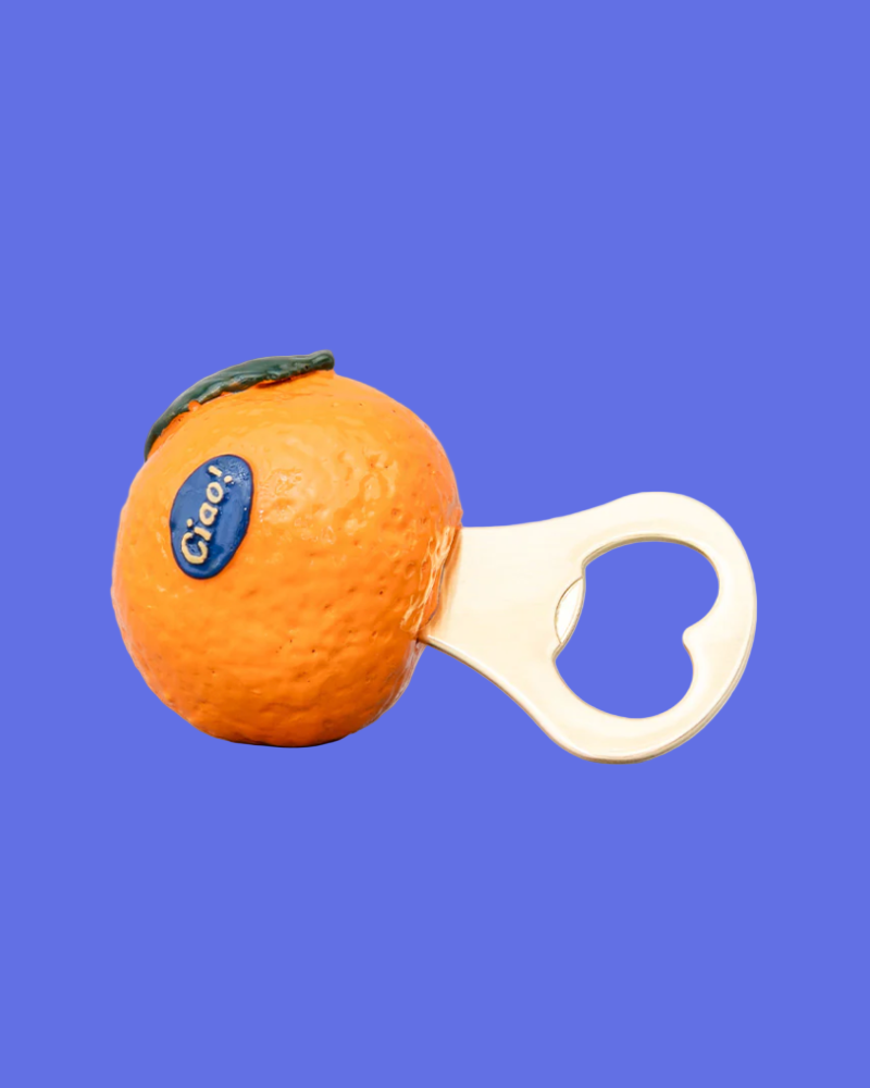 Orange-shaped bottle opener with a blue label on a blue background