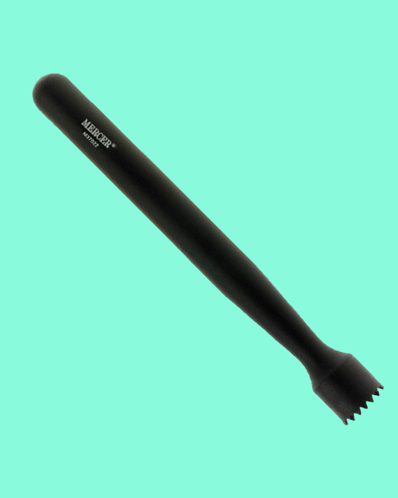 Black tool with textured end on a teal background