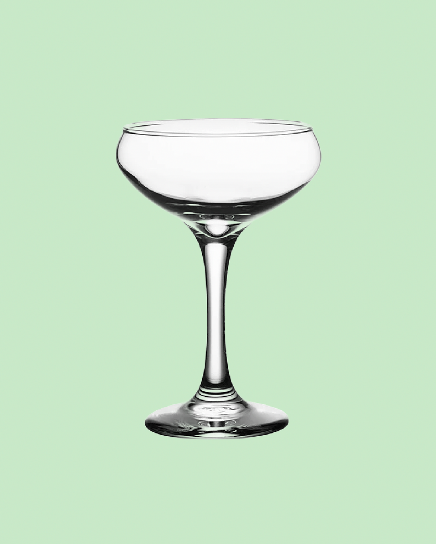tall coupe wine glass on a green background