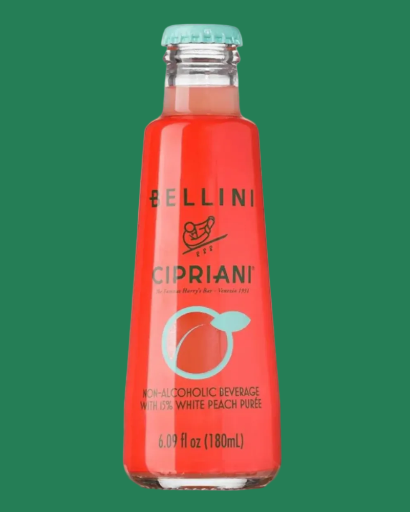 Red bottle of Cipriani Bellini on a green background