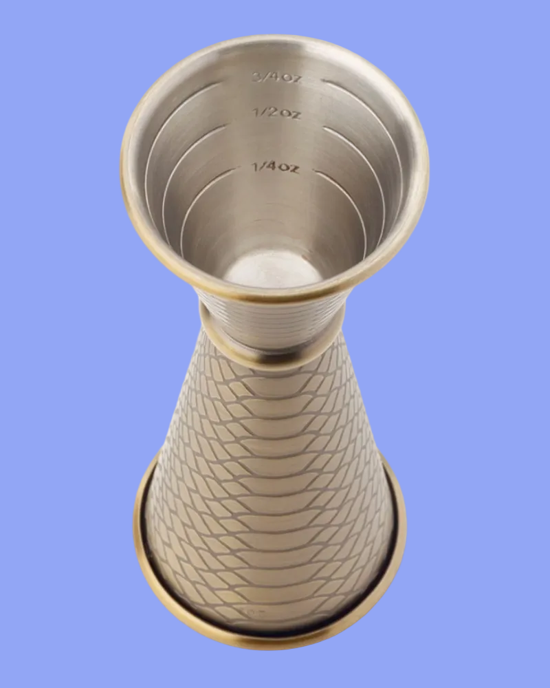 Metallic cocktail shaker with measurement markings on a white background