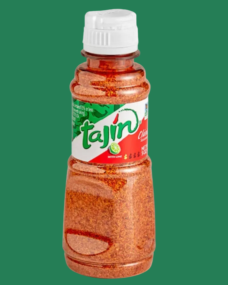 Bottle of Tajin seasoning on a green background