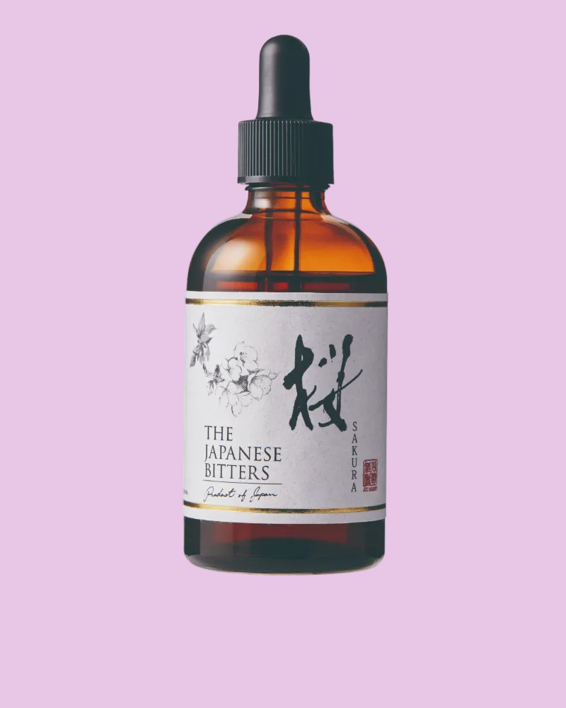 Bottle of 'The Japanese Bitters Sakura' on a pink background