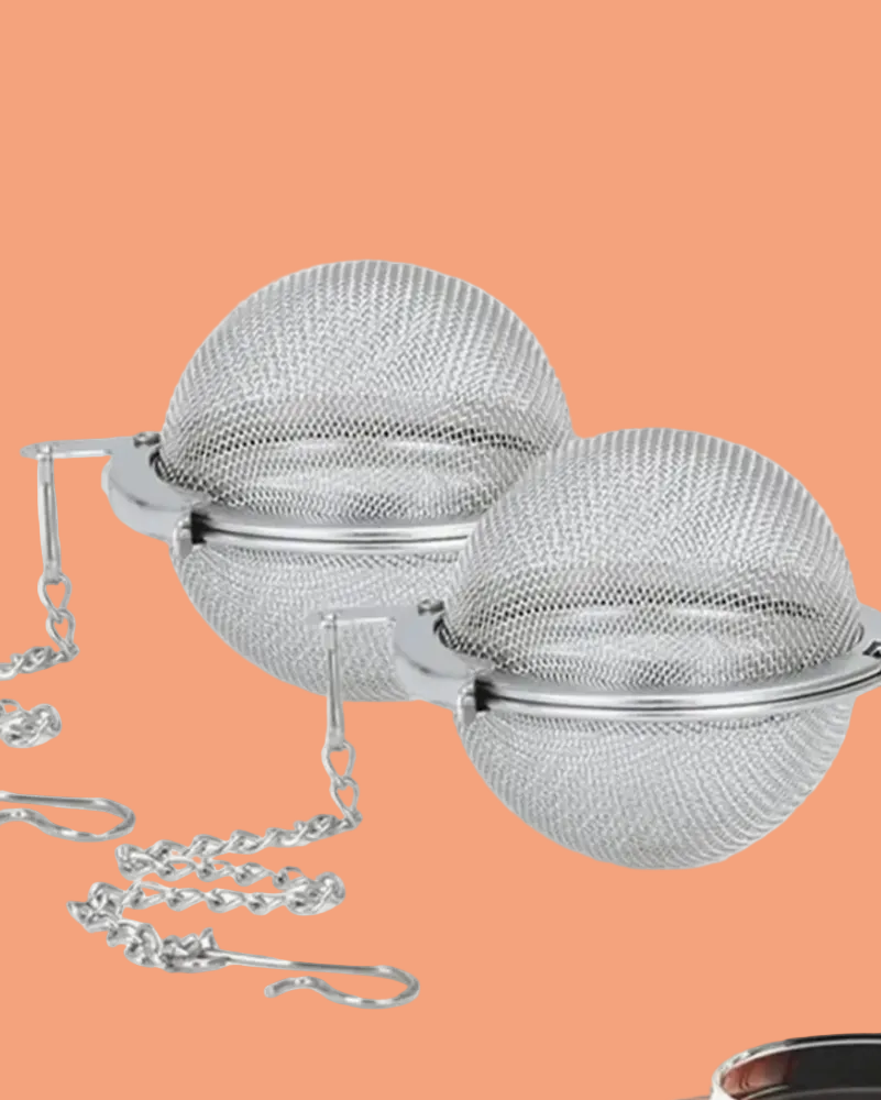 Metallic tea ball with chain on a white background