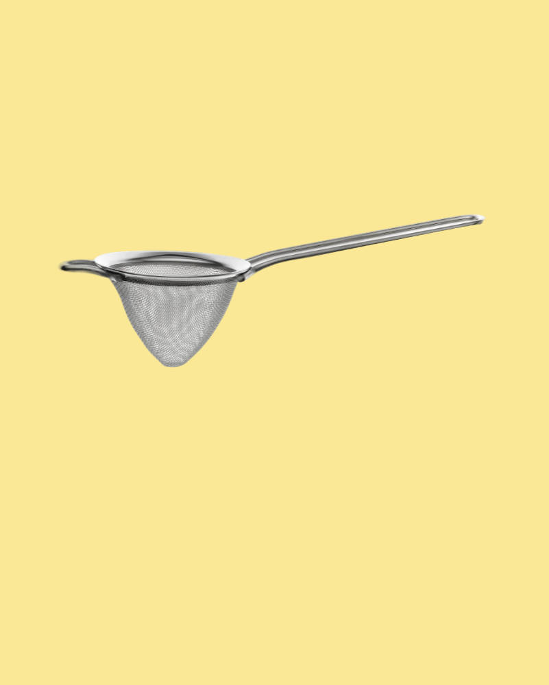 silver strainer on yellow background