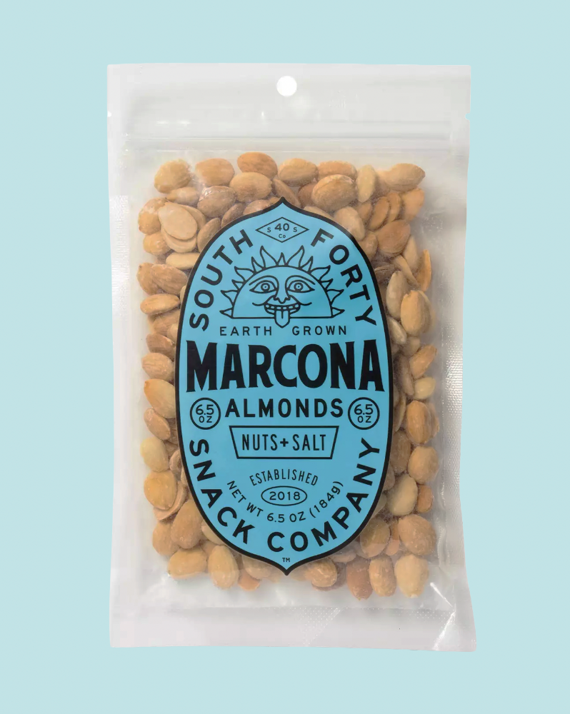 Packaged Marcona Almonds from South Forty Snack Company on a light blue background