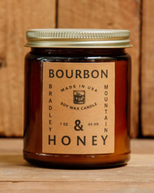 Jar of Bourbon & Honey candle with a wooden background