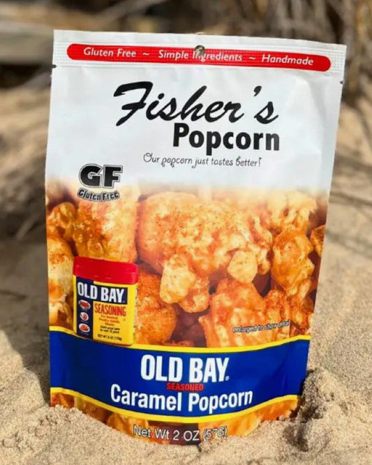 Fisher's Popcorn Old Bay Caramel Popcorn package on sand