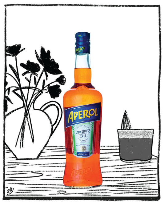Aperol bottle on a table with a black and white illustration of flowers and a candle in the background