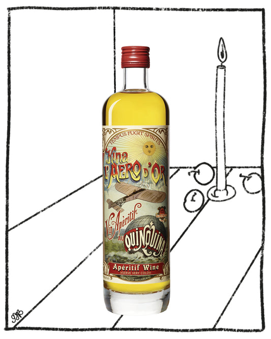 Bottle of 'The Quinquin' aperitif wine with a label featuring a penguin, next to a candle on a white background.