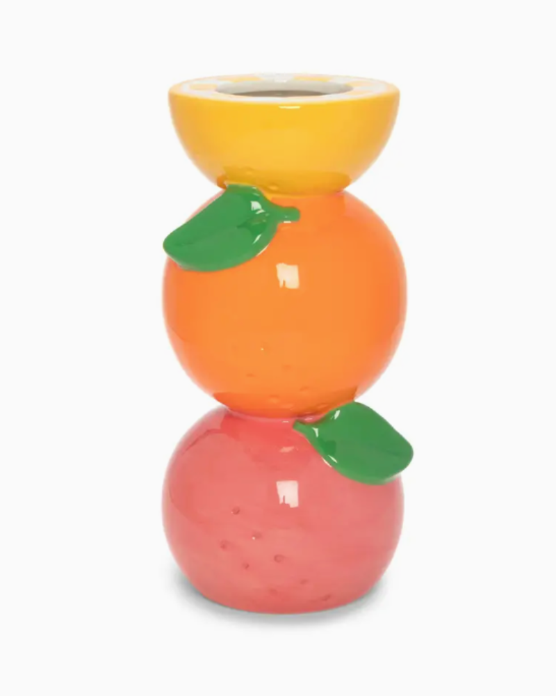 Stacked ceramic fruit-shaped candle holders on a white background