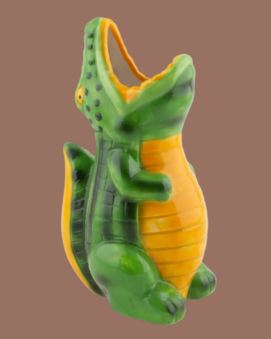 Green and yellow lizard-shaped container on a white background