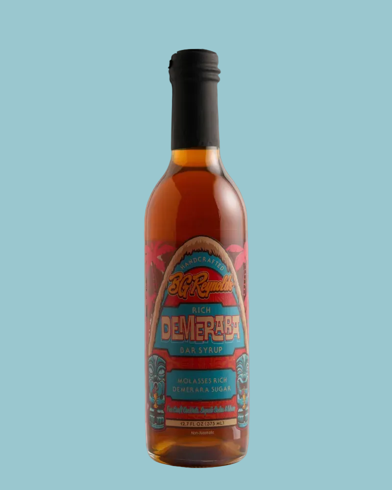 A bottle of St. Rudolph's Rich Demerara Bar Syrup with a black cap, set against a solid light blue background.