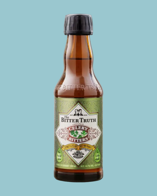 A bottle of The Bitter Truth Celery Bitters on a light gray textured background. The product features an amber glass bottle with a black cap and a green and white label.