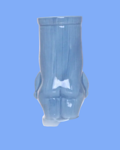 Blue ceramic vase with a unique design on a white background