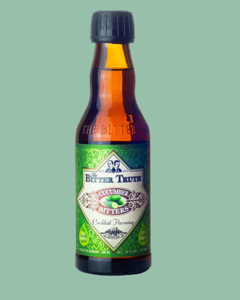 A bottle of Bitter Truth Cucumander Bitters, cocktail flavoring, featuring a green label and dark cap on a solid sage green background.