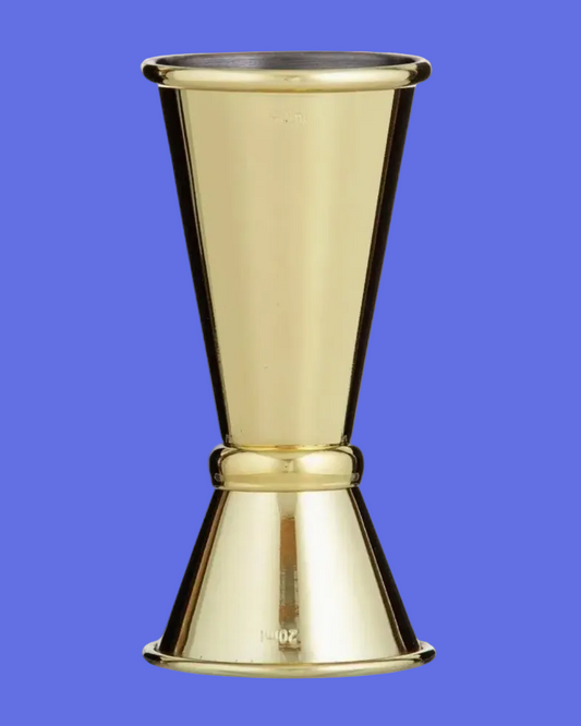 A polished brass jigger with a flared base and a conical top, featuring engraved ounce markings near the base, set against a plain white background.