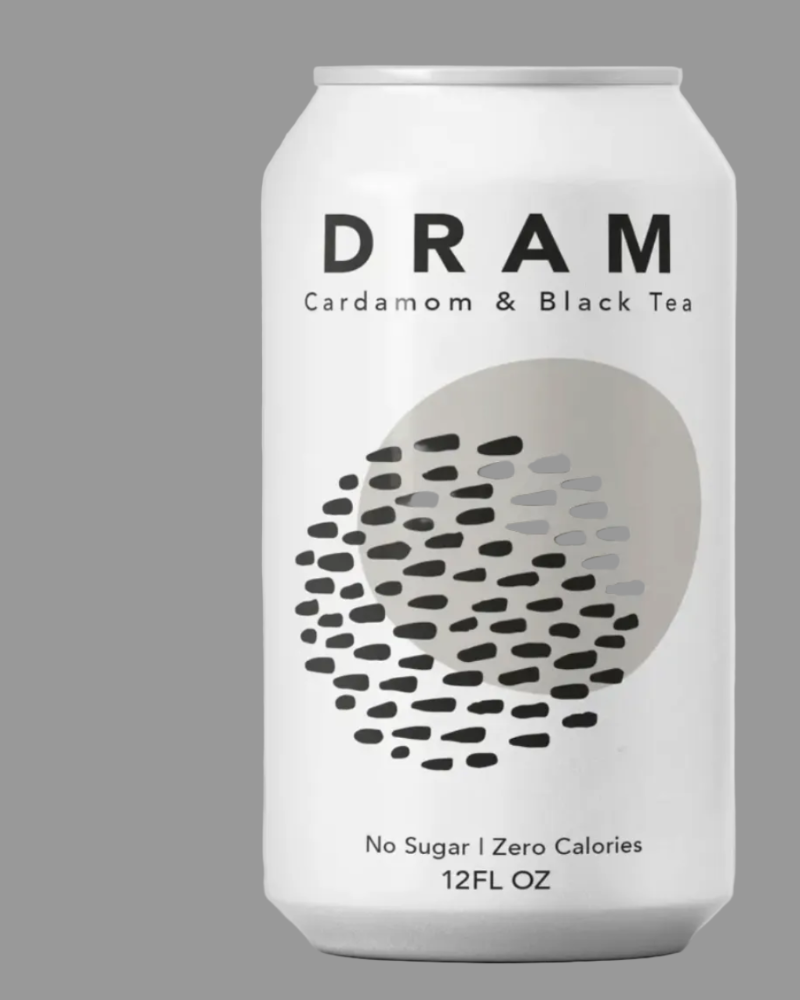 A white aluminum can of DRAM Cardamom & Black Tea on a solid gray background. The can features black text and a graphic of black and gray dots inside a light gray circle.