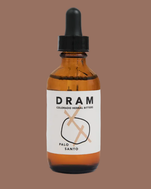 An amber glass dropper bottle of DRAM Palo Santo Colorado Herbal Bitters with a white label and black dropper cap, set against a solid light gray background.