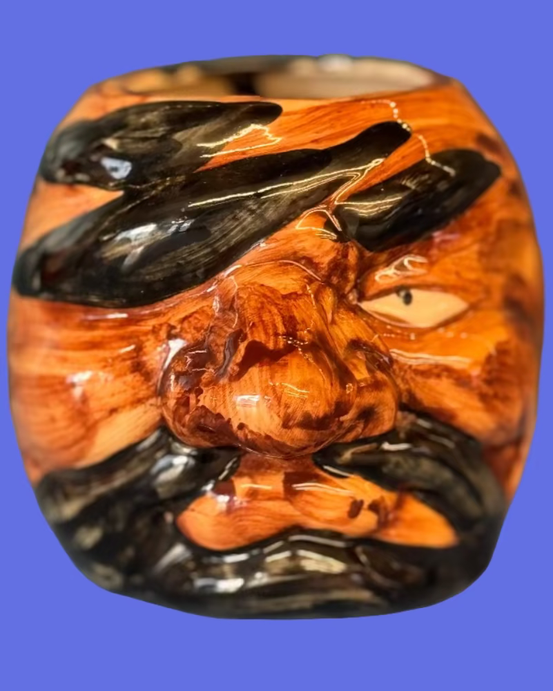 Tiki ceramic pirate mug with eye patch and beard on a blue background