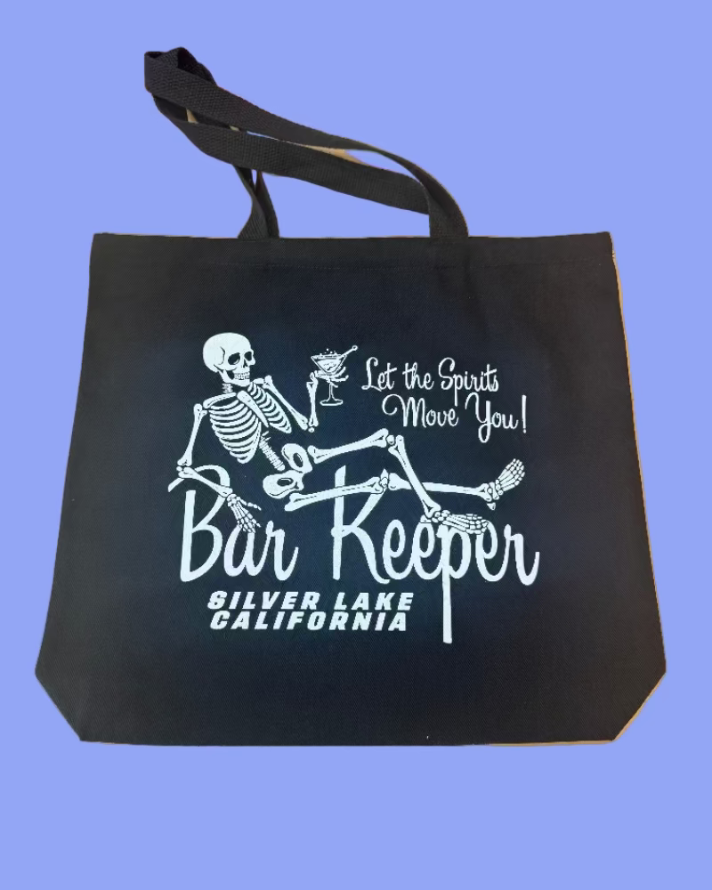 Black tote bag with skeleton design and text on a blue background