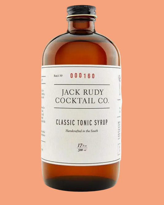 A bottle of Jack Rudy Cocktail Co. Classic Tonic Syrup in an amber glass bottle with a black cap and a white label.
