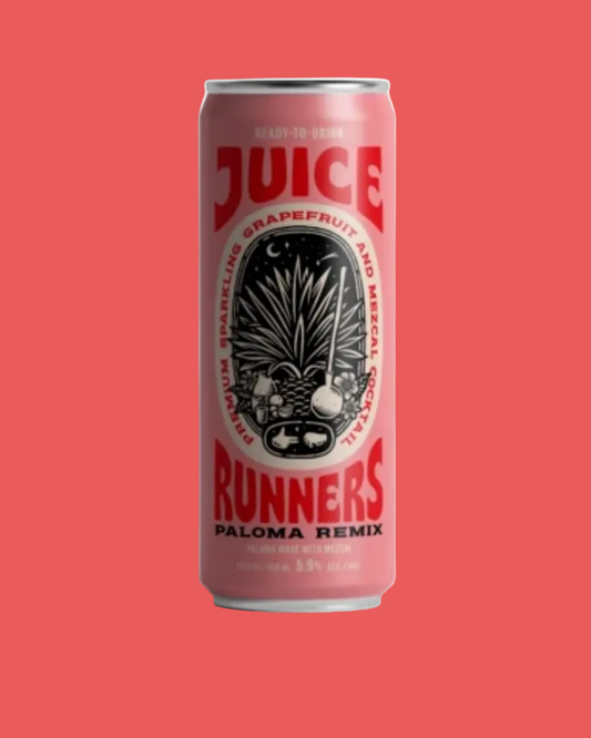 A single can of Juice Runners Paloma Remix beverage centered on a solid coral-red background. The can is light pink with bold red lettering reading 'JUICE RUNNERS' and a black central illustration, plus smaller text including 'Grapefruit and Passionfruit'.