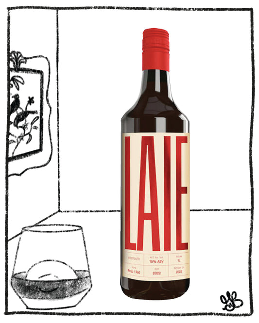 Wine bottle with red cap and label, next to a glass of wine on a black and white background.