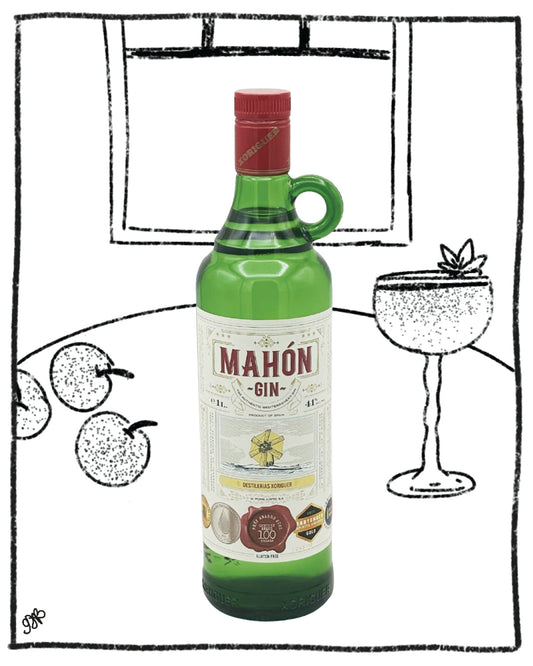 Bottle of Mahon Gin with a glass and cherries in the background