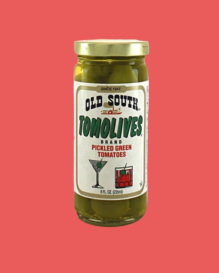 Jar of Old South Tomolives pickled green tomatoes on a red background