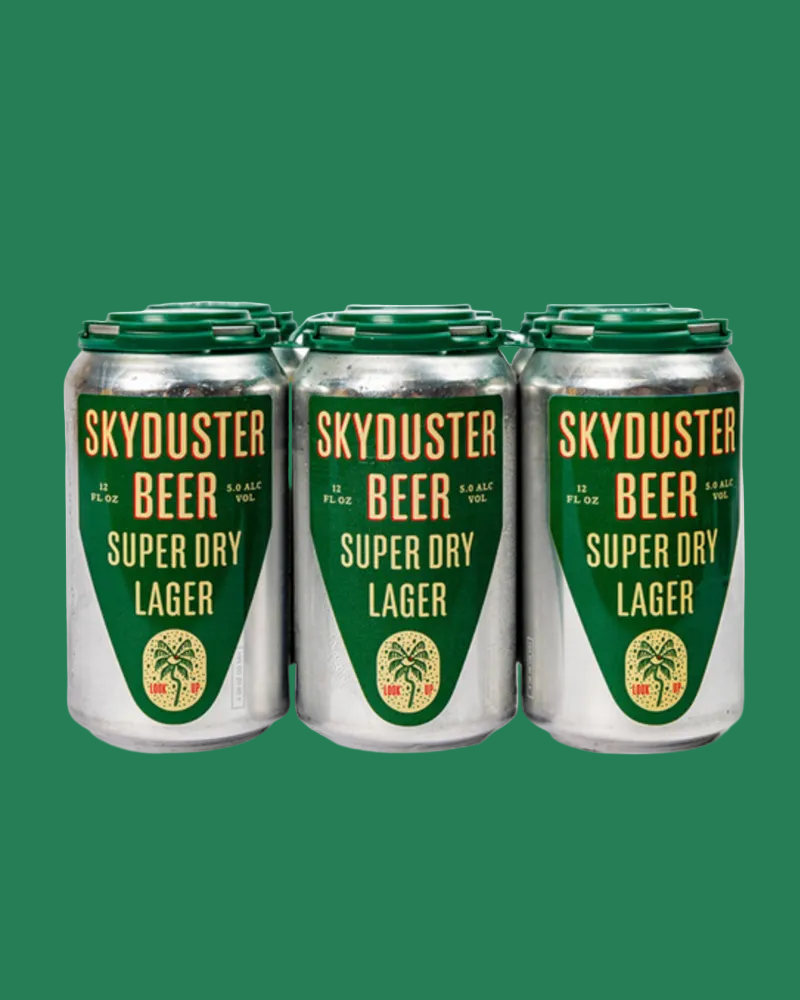 Six aluminum cans of Skyduster Beer Super Dry Lager arranged in a row against a solid green background.