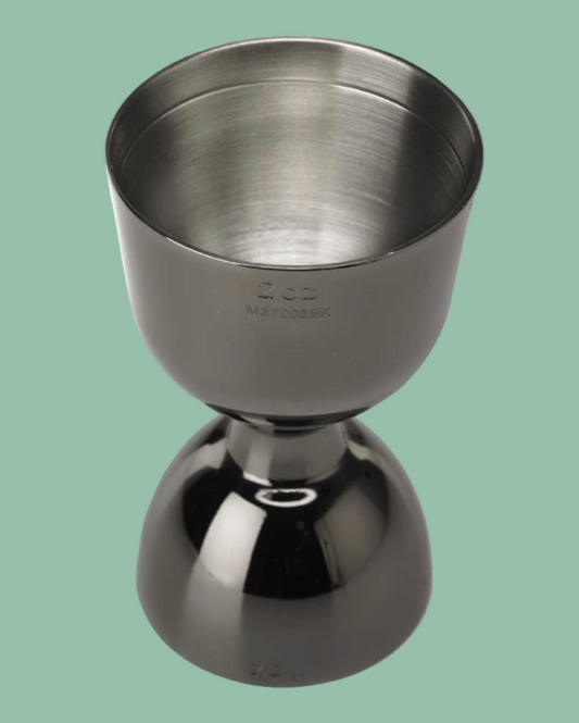 Metallic jigger on a green background