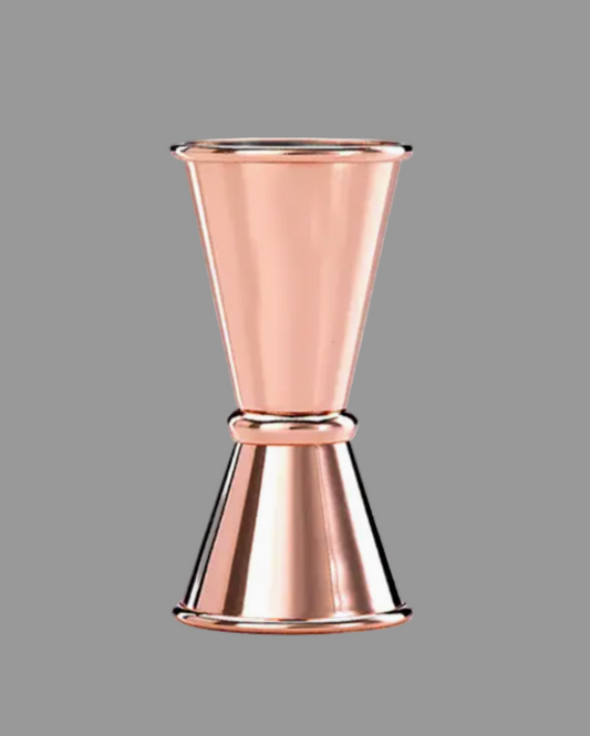 Copper jigger on a gray background