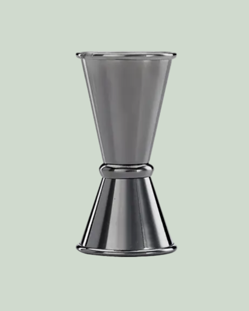 Metallic cocktail shaker on a light green background