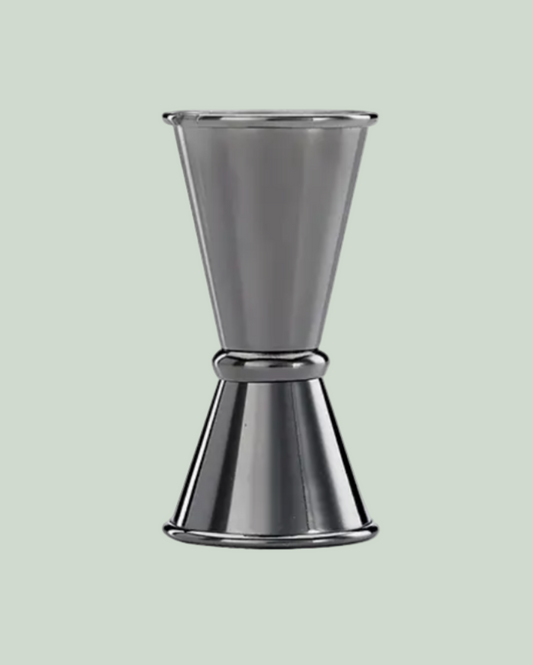 Metallic cocktail shaker on a light green background