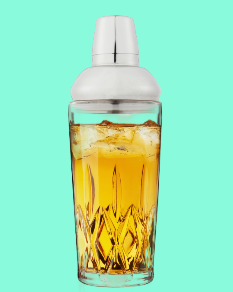 Cocktail shaker with a drink inside on a teal background