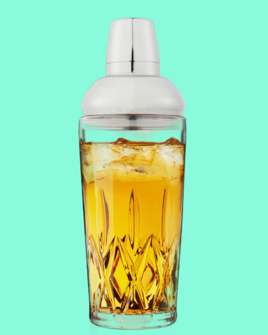 Cocktail shaker with a drink inside on a teal background