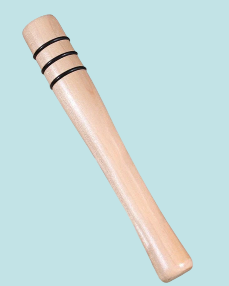 Wooden cylindrical object with black bands on a light blue background