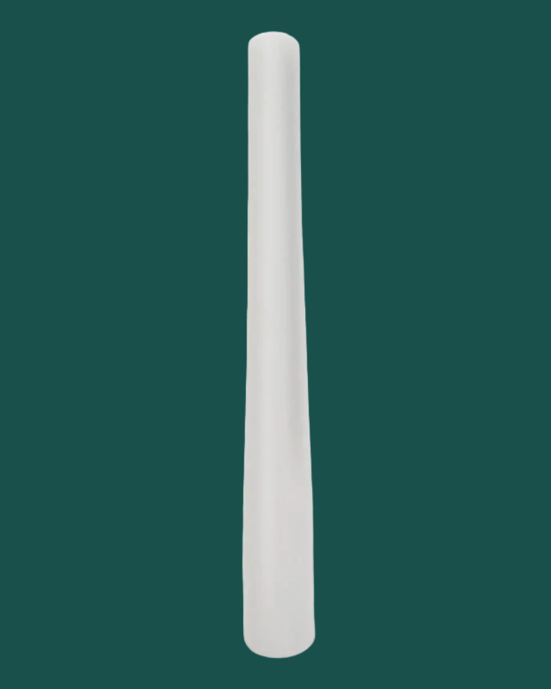 White cylindrical object on a green background