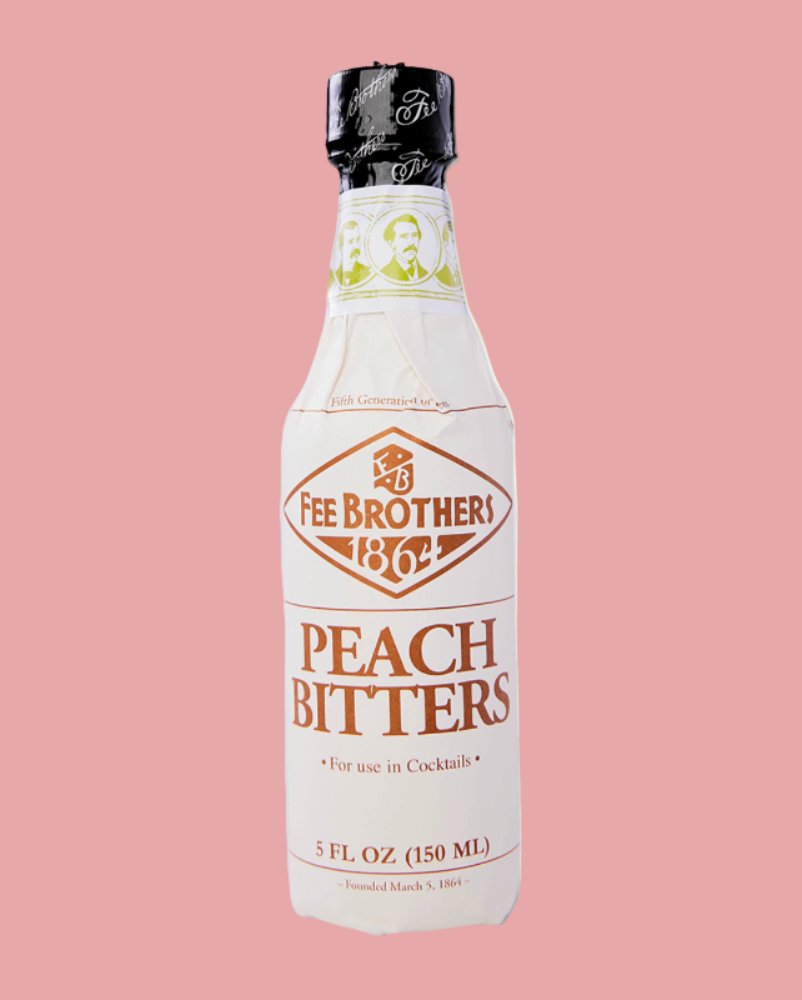 Bottle of Fee Brothers Peach Bitters on a pink background