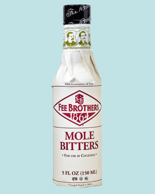 Bottle of Fee Brothers Mole Bitters on a light blue background