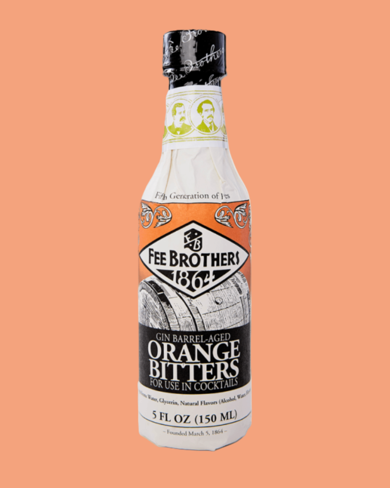 Bottle of Fee Brothers Gin Barrel Aged Orange Bitters on a peach background
